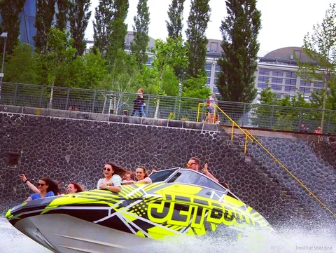 Captain steering the Frankfurt speedboat tour along the River Main