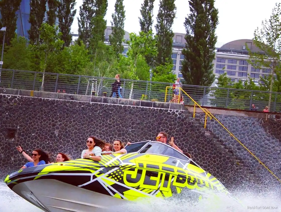 Captain steering the Frankfurt speedboat tour along the River Main